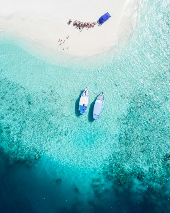 Kayaks on turquoise water, aerial