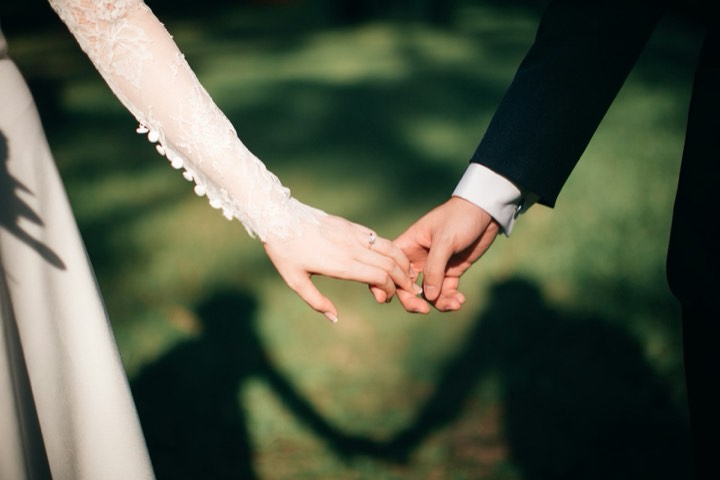 Backlit couple with bouquet